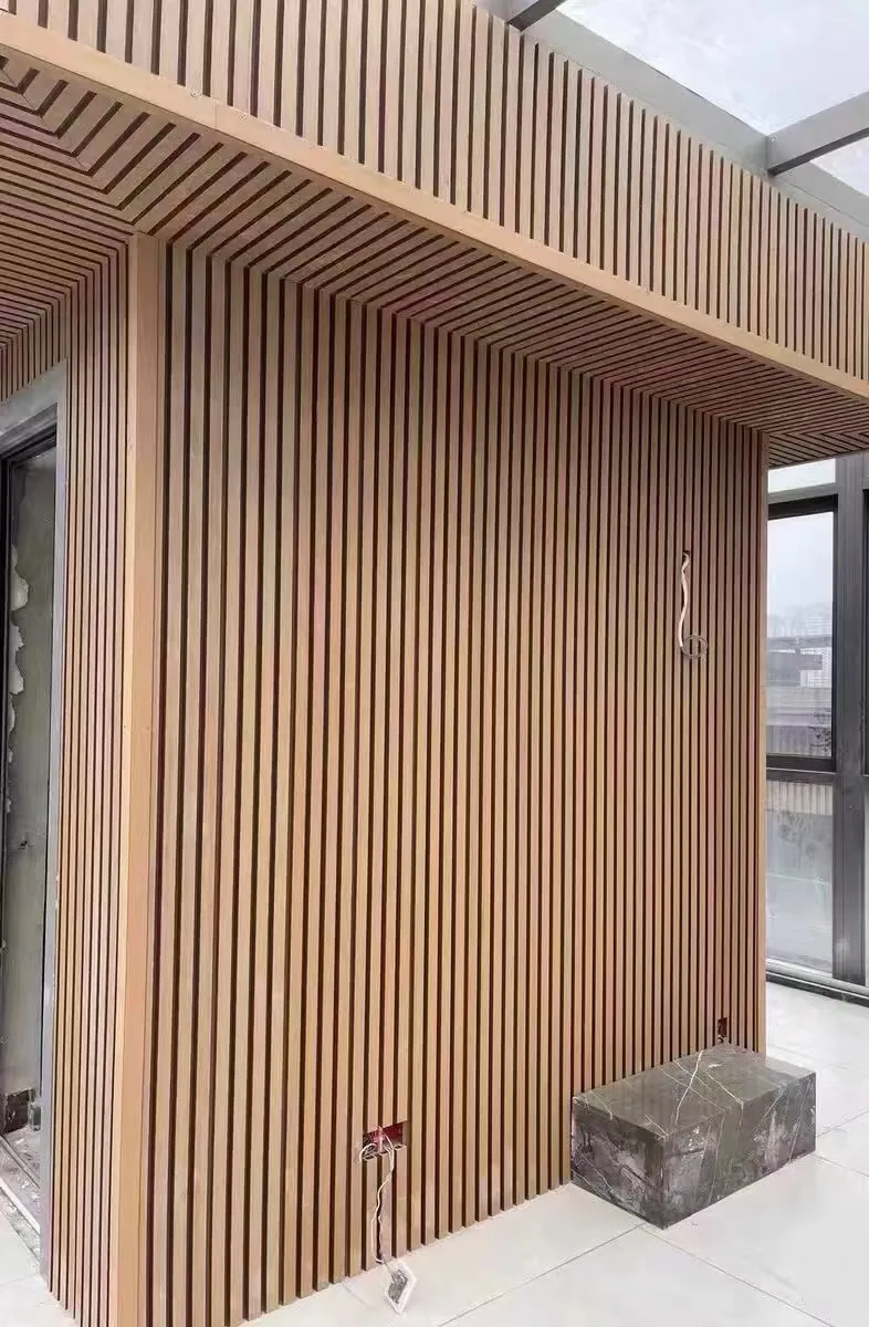Co-extruded cladding installed across a wall and soffit